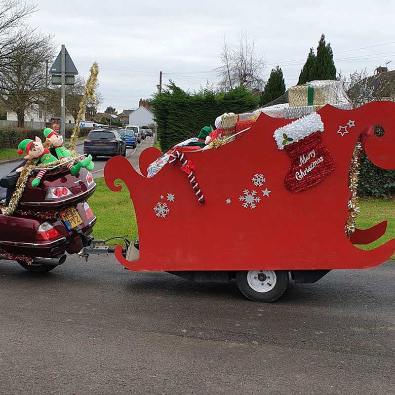 Santa Claus is riding a bike